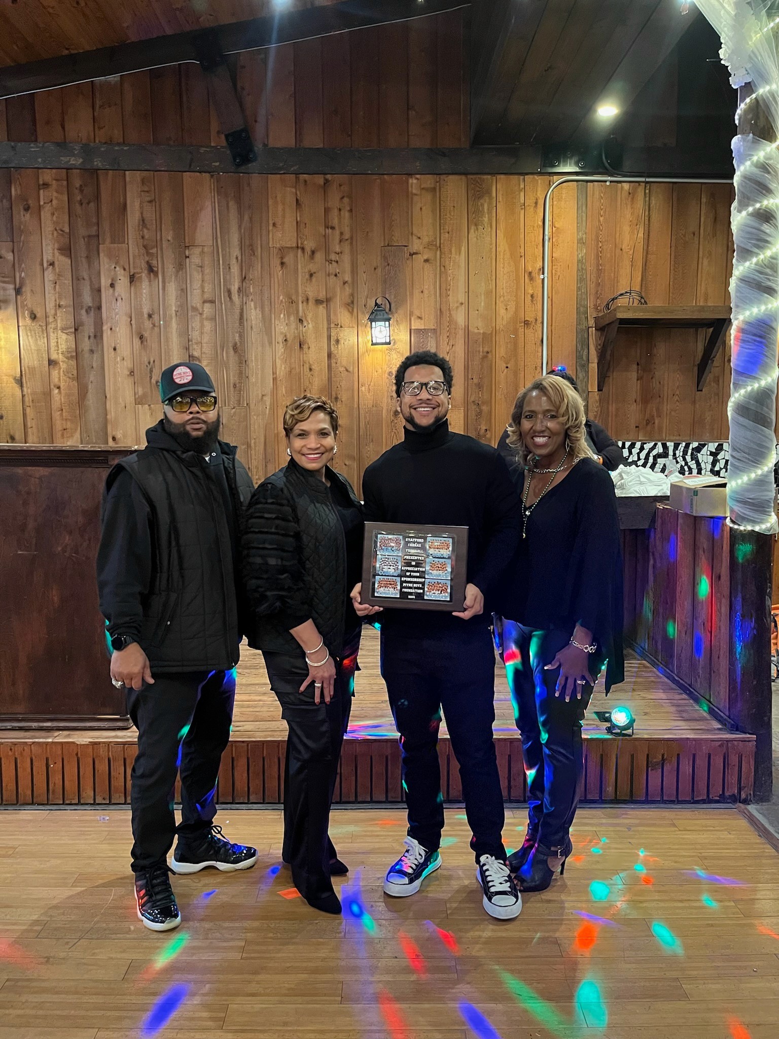 Four family members holding  an award smiling. 