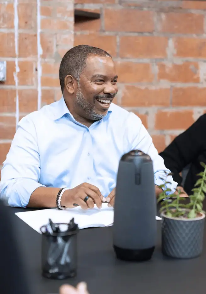 Man laughing at a marketing meeting