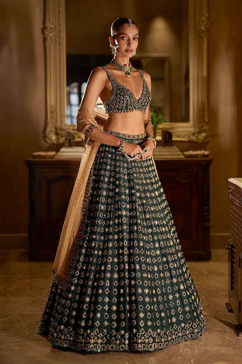 Emerald green bridal lehenga with gold stone and zardozi work by Seema Gujral
