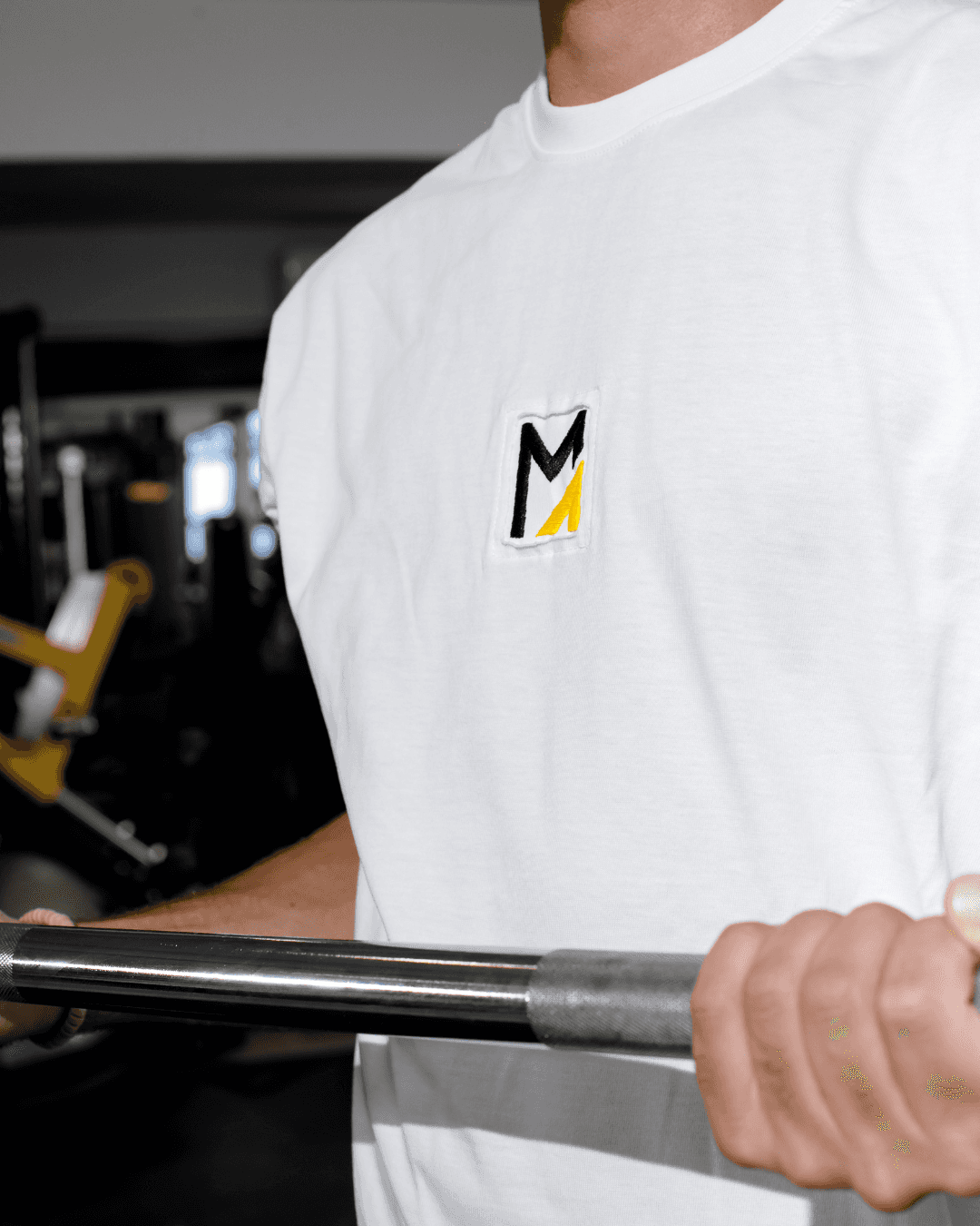 A long-haired man resting his arm on gym equipment while holding a water bottle. Quote: “I’ve tried gyms, apps, and diets – nothing compares to this program…” – Account Executive.