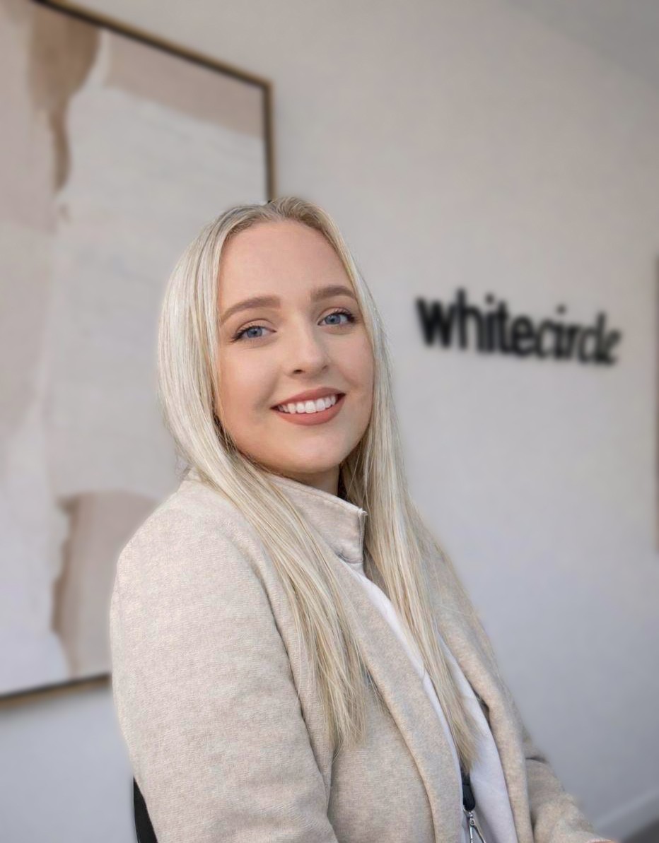 a woman with long hair wearing a blue blazer