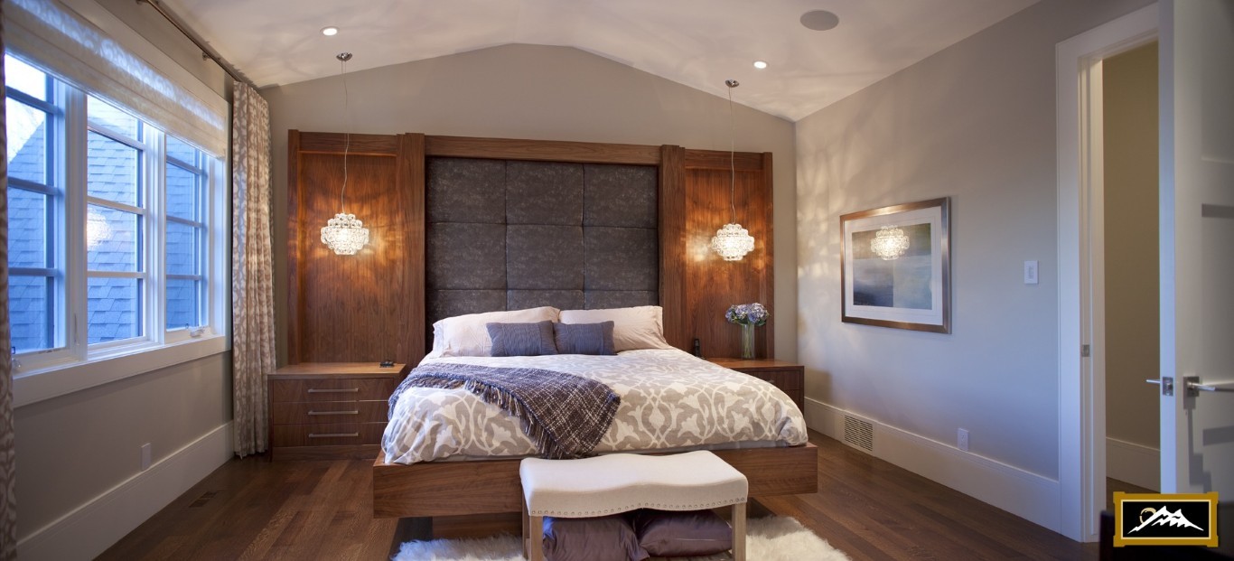 Image of Luxurious primary suite with plush bedding, wooden accents, and elegant window coverings by KHD Homes.