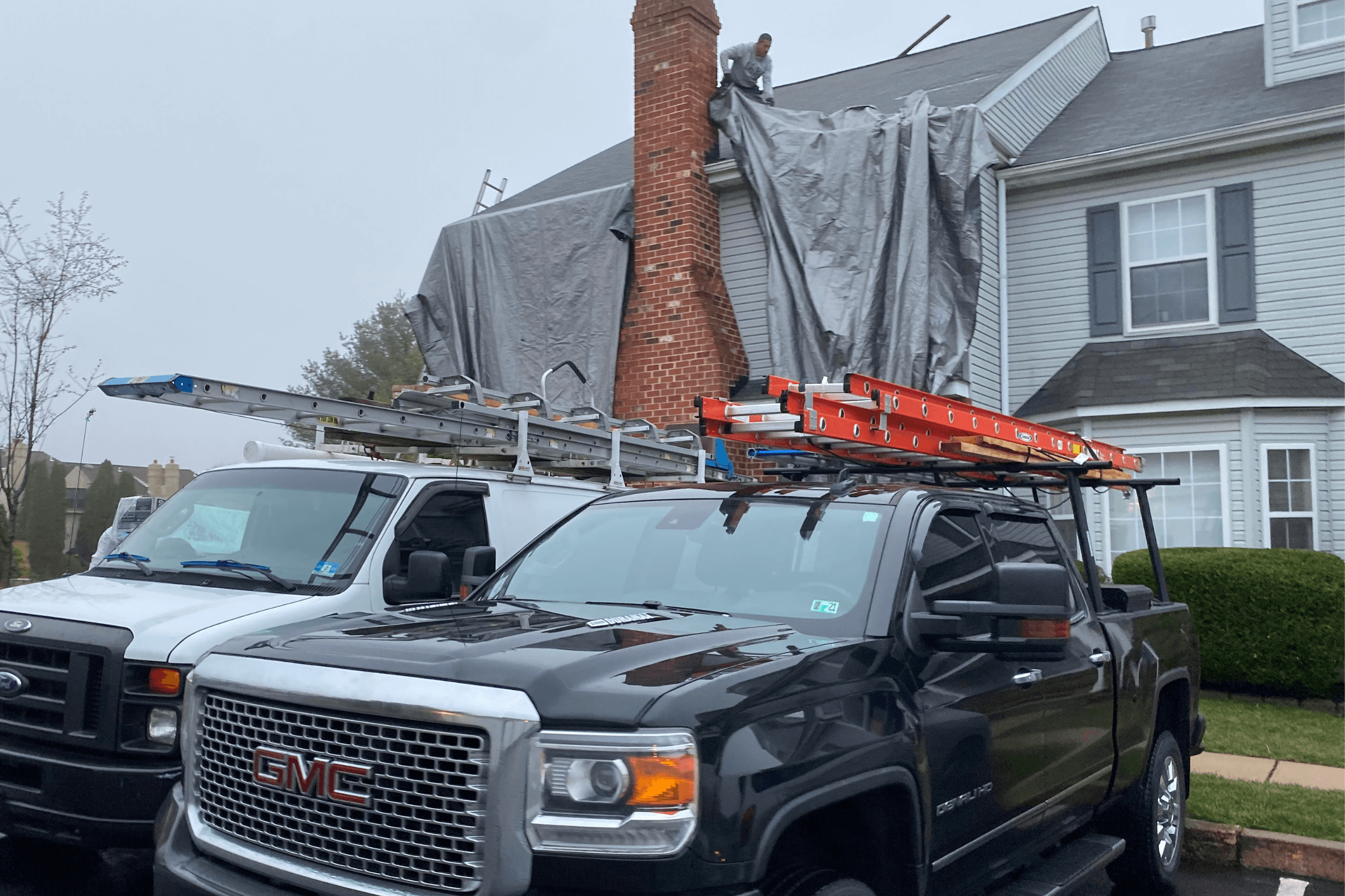 Setting up tarps on home before roof tear off in Gladstone, Missouri