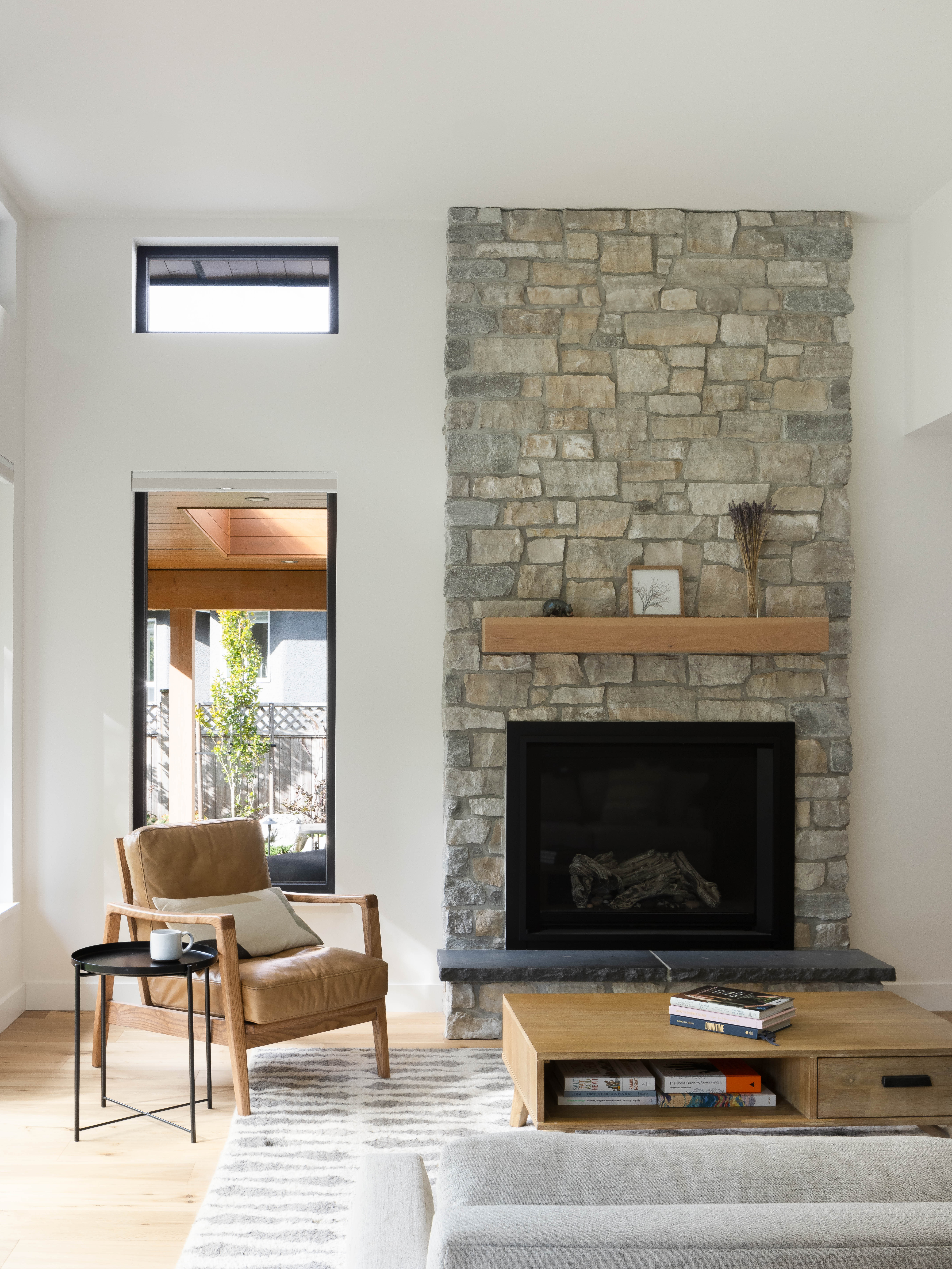 finished living room with stone fireplace | homeowner hq