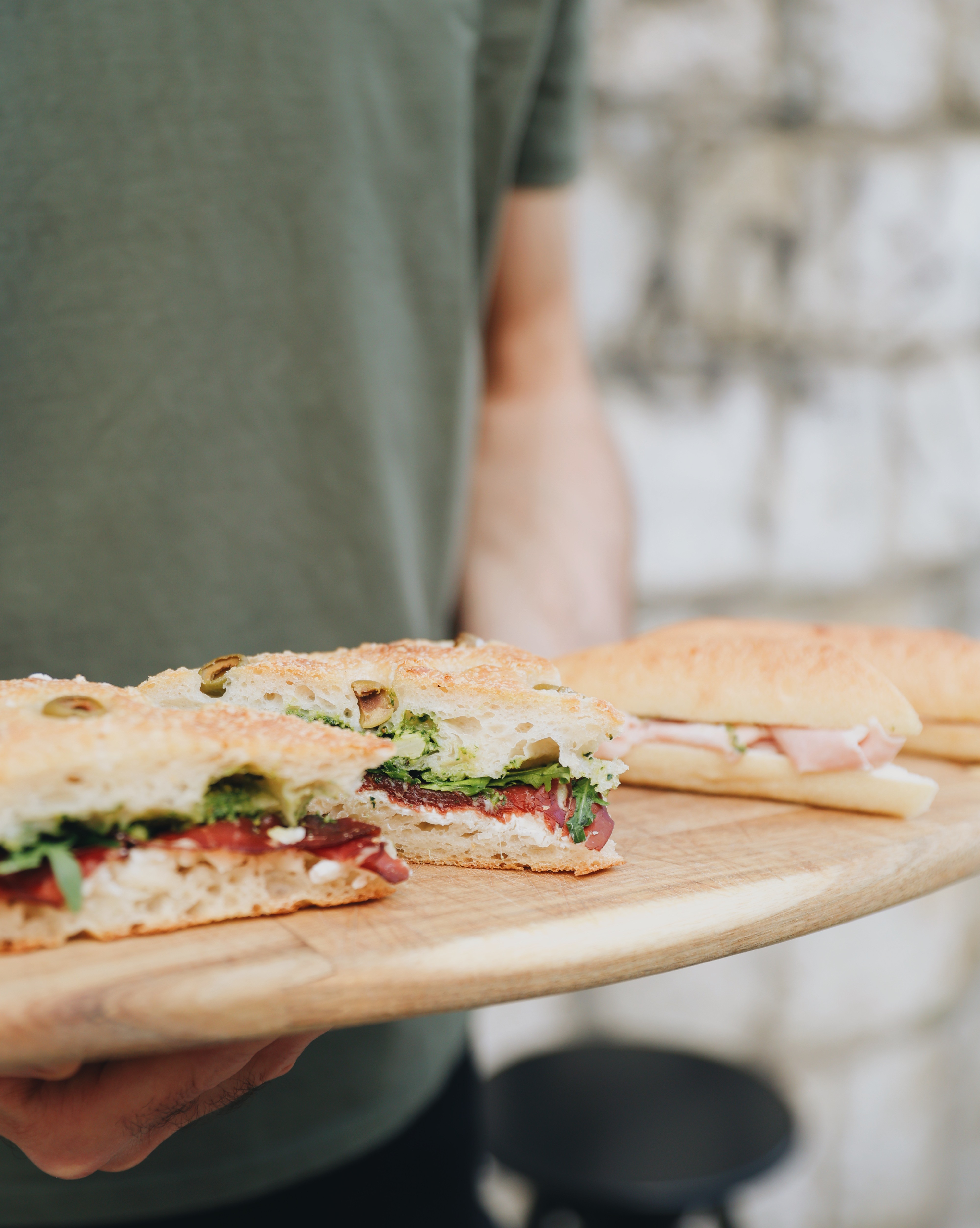 Fresh wholegrain sandwiches served on a wooden board at Jo & The Sisters Morning Club.