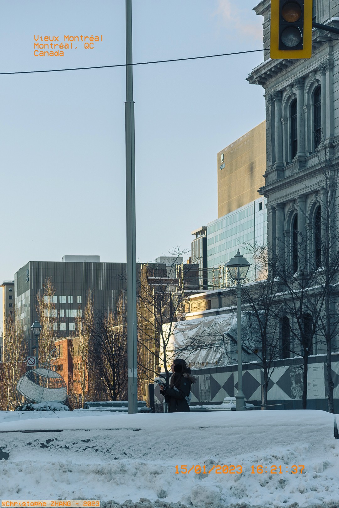 Scène tranquille d'hiver dans le Vieux-Montréal, un photographe capture l'architecture historique.