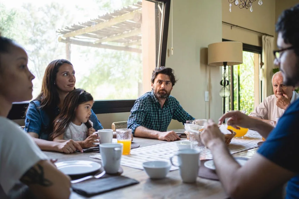 family members talking while eating lunch