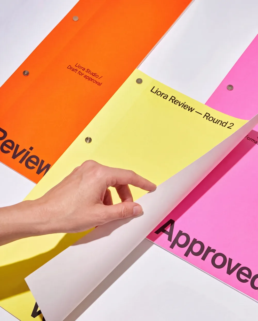 Colourful review folders marked Approved for a Liora client review