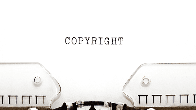 typewriter with paper that has "copyright" typed onto it