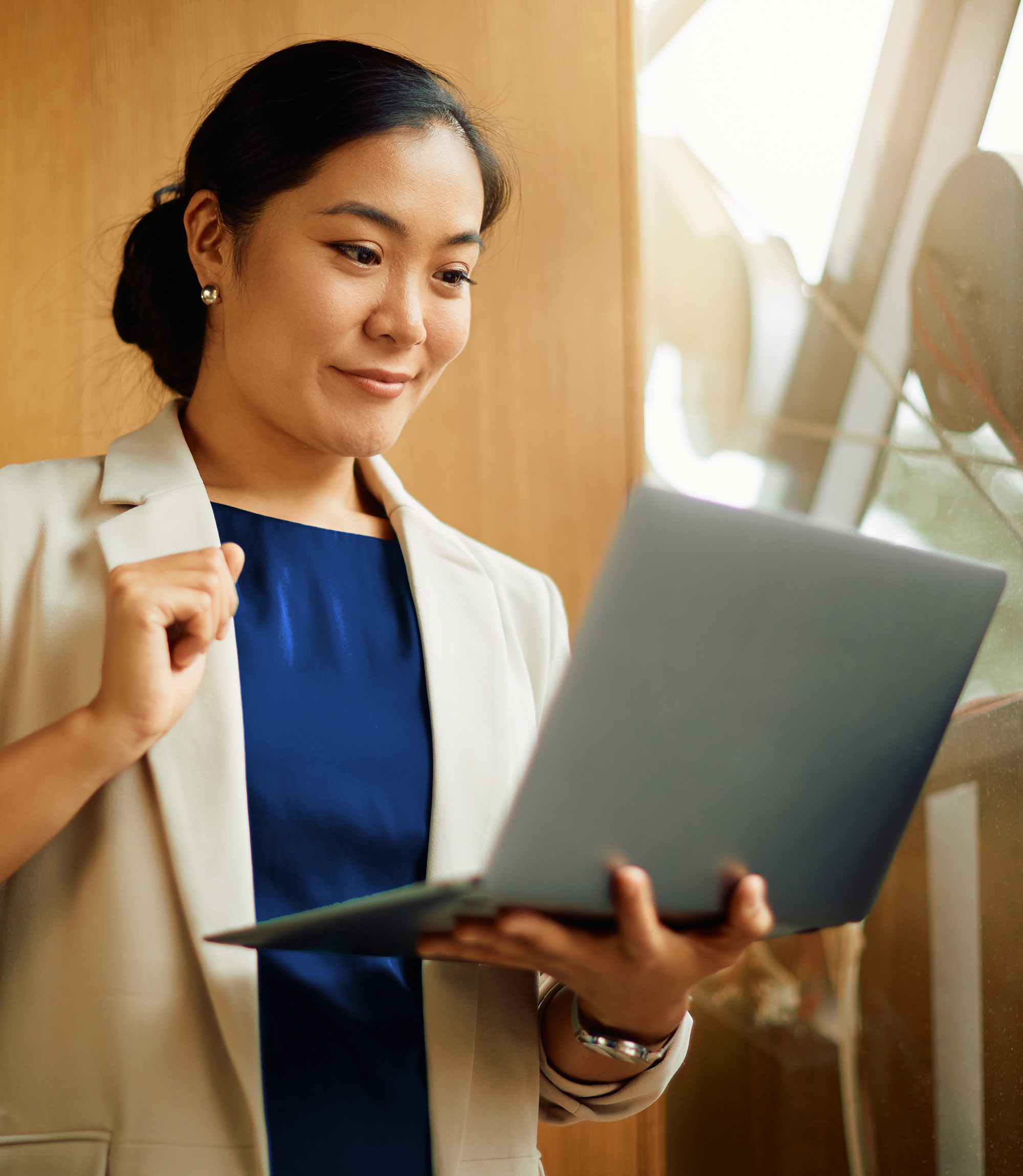 a happy business person looking at the laptop screen