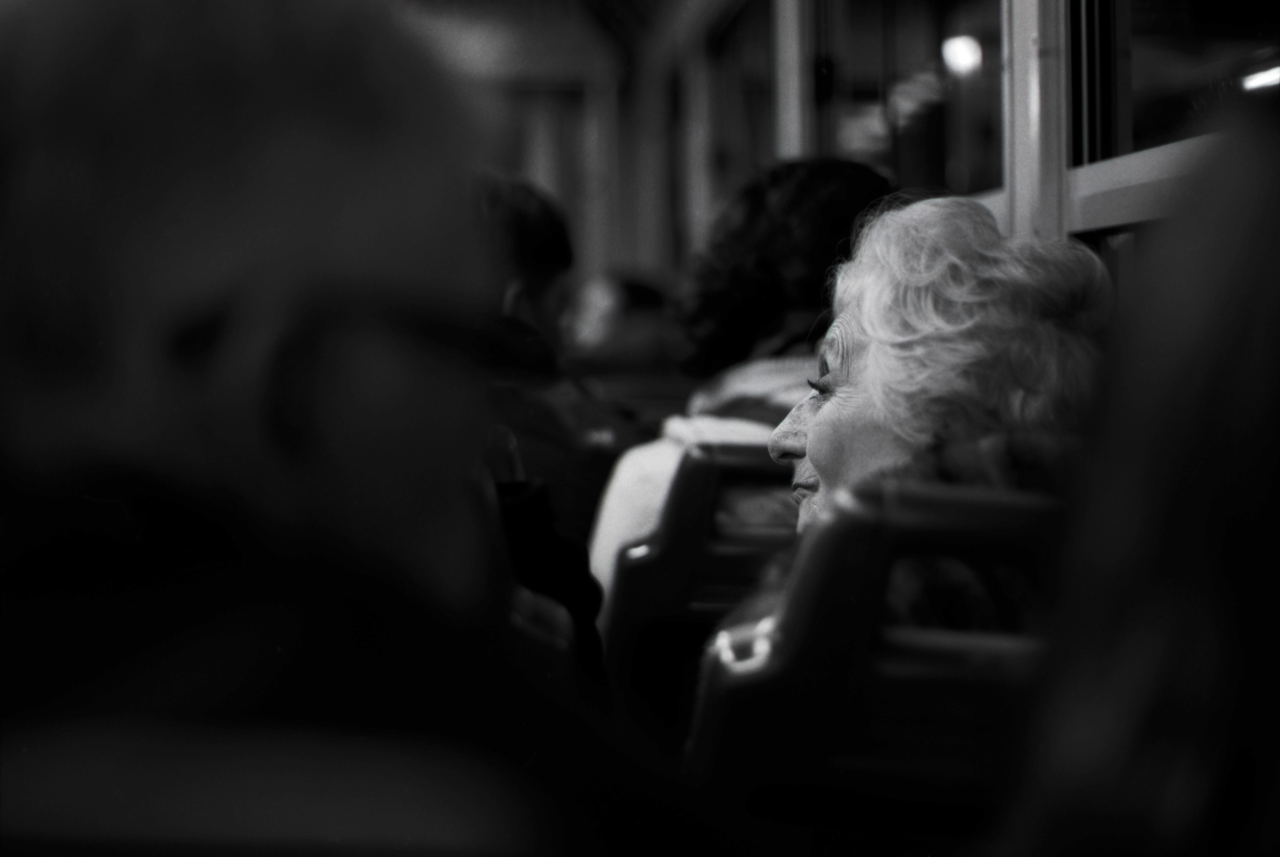 Elegant older lady in the crowd of a vaporetto in Venice