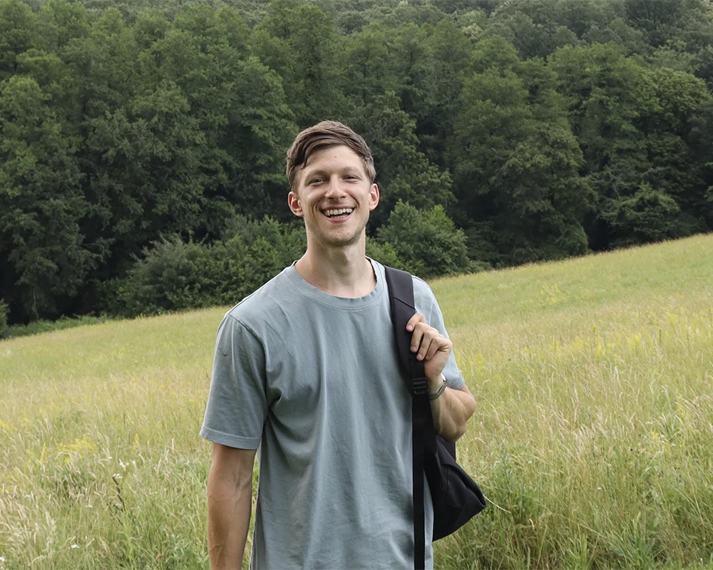 Portrait image of man smiling in forest