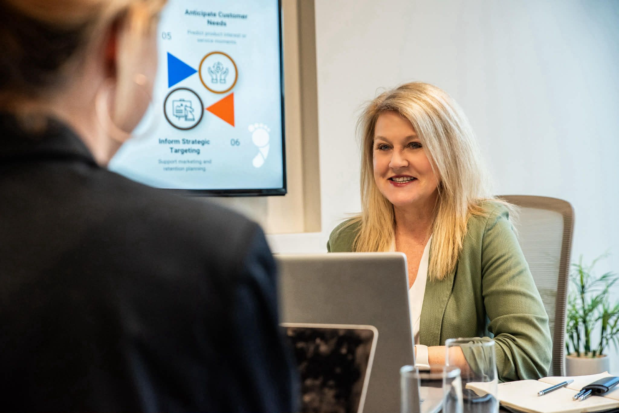 Two smiling women pose indoors at The Crate Hamilton.