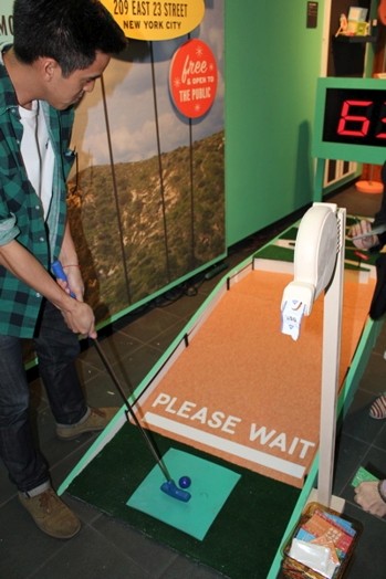 a man is trying to play mini golf