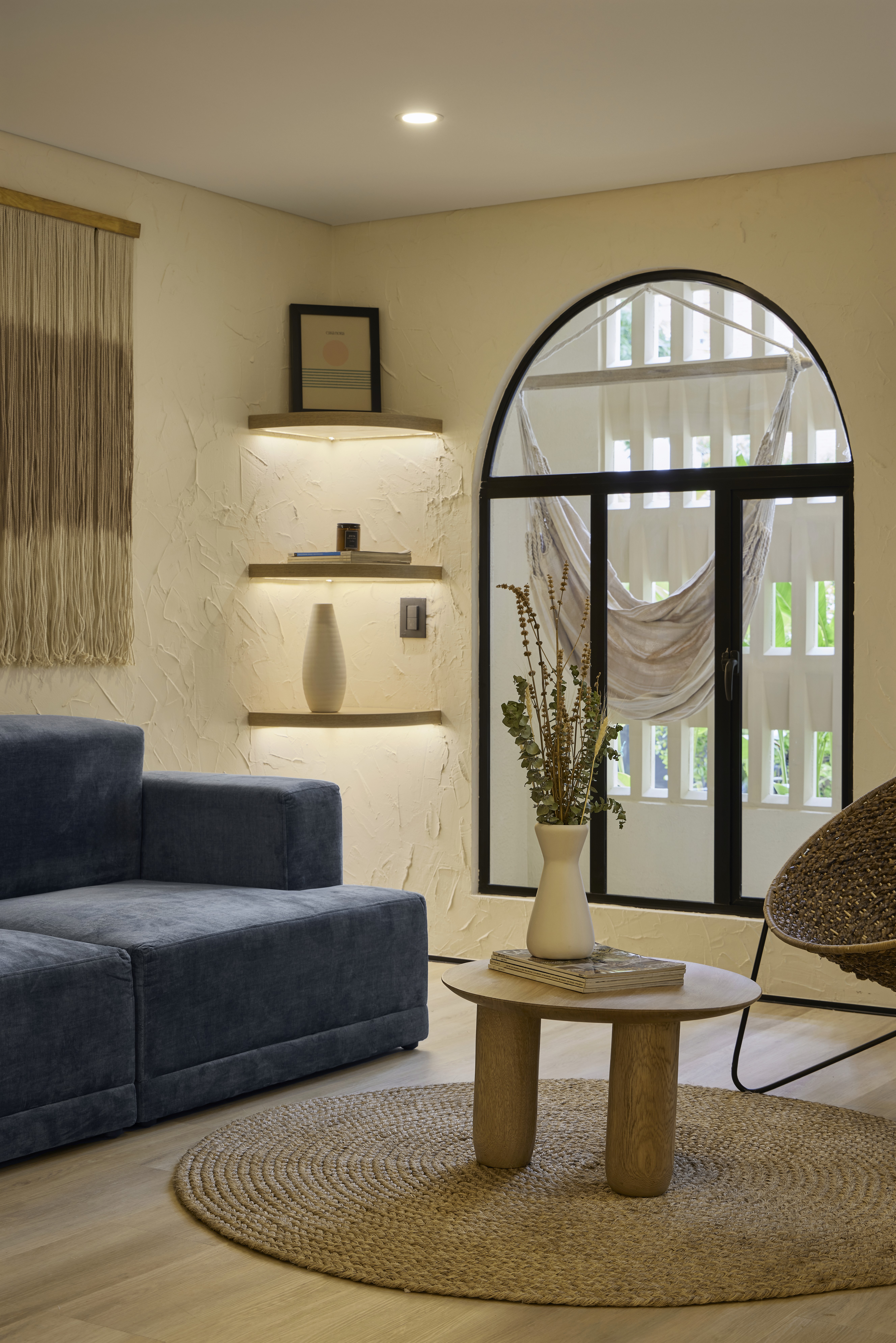 Double-height interior with flowing sculptural forms and warm raking light