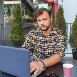 Asher on a laptop outside profile picture
