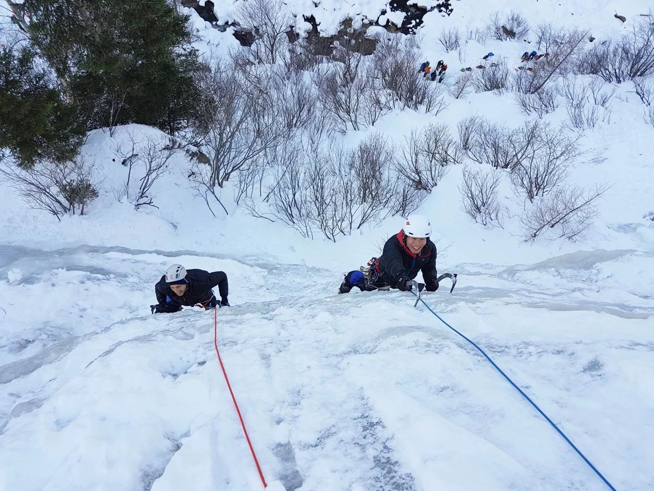 Ice climbing a ice waall in the dolomites