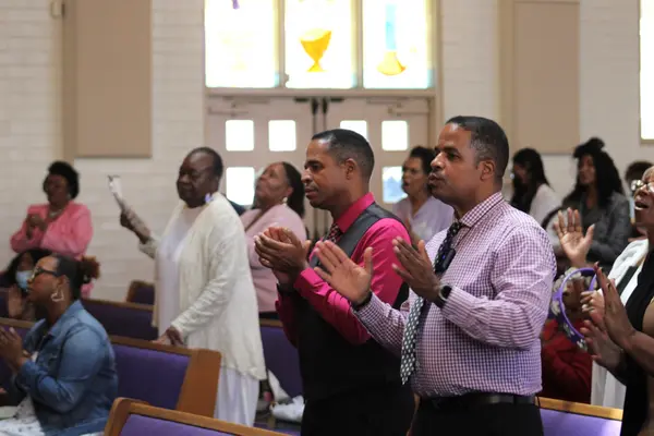 Congregation clapping during worship service at Peace Apostolic Church