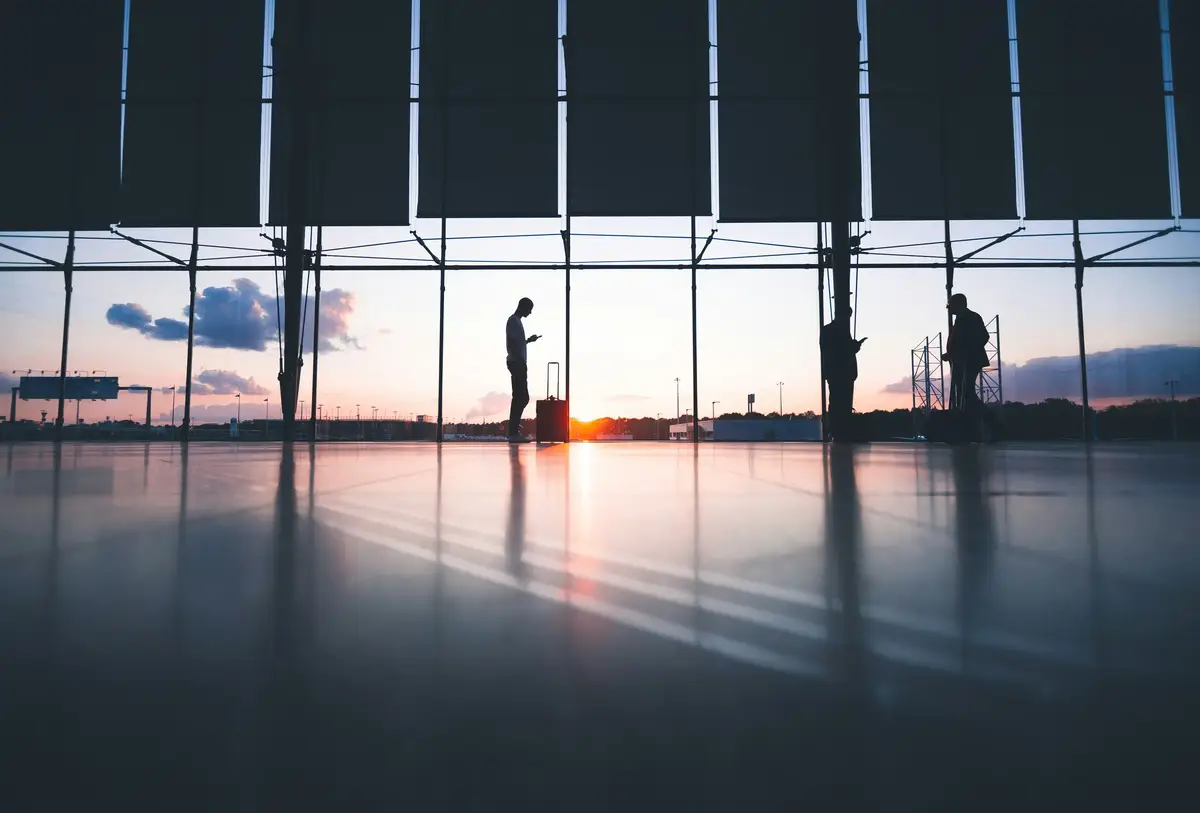 an airport terminal and passengers
