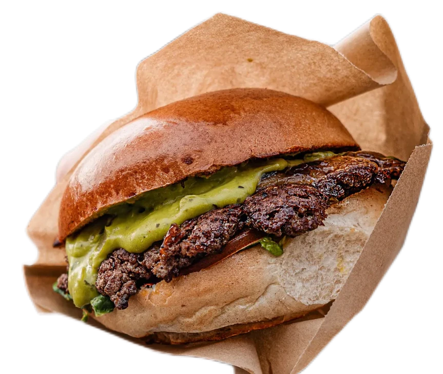 A delicious hamburger with a beef patty, pickles, and soft bun, served in a paper wrapper.