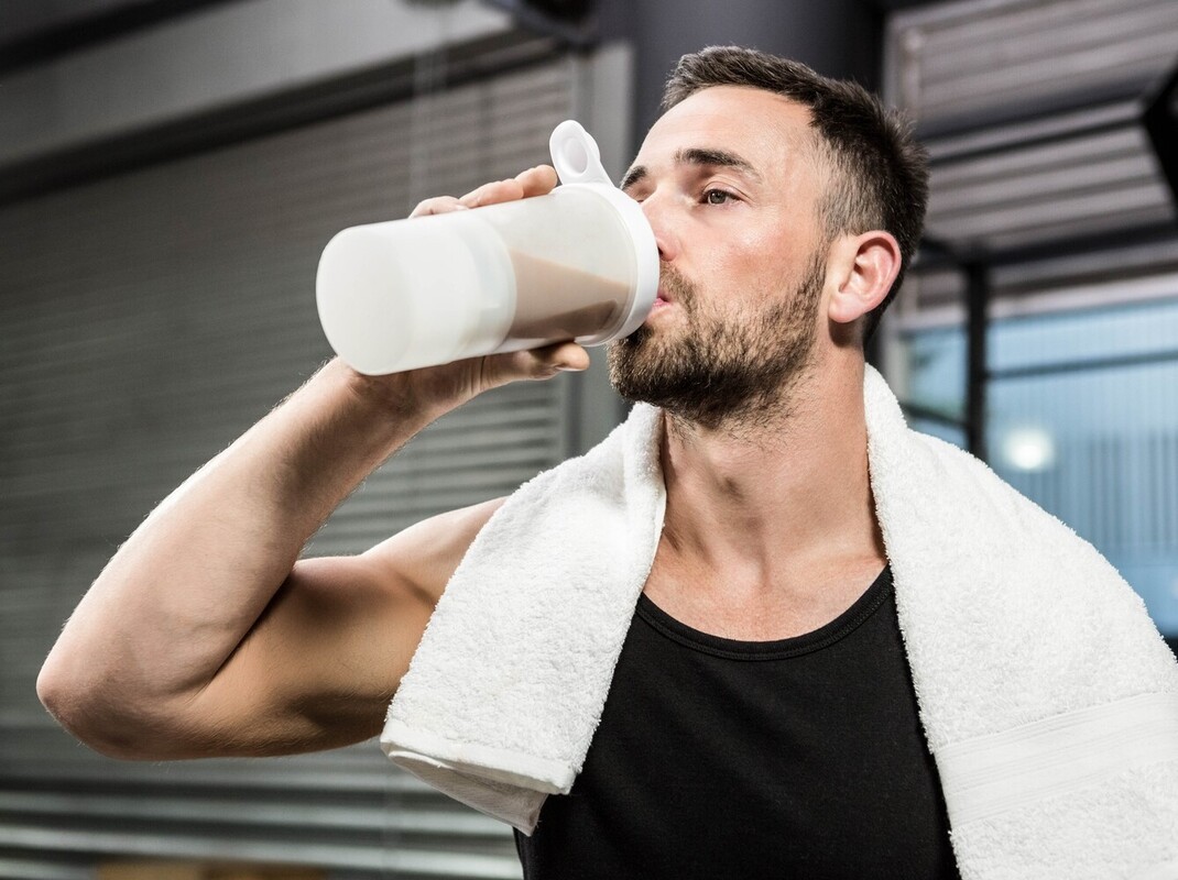 man drinking a protein shake after increasing how long on StairMaster to lose weight he normally does