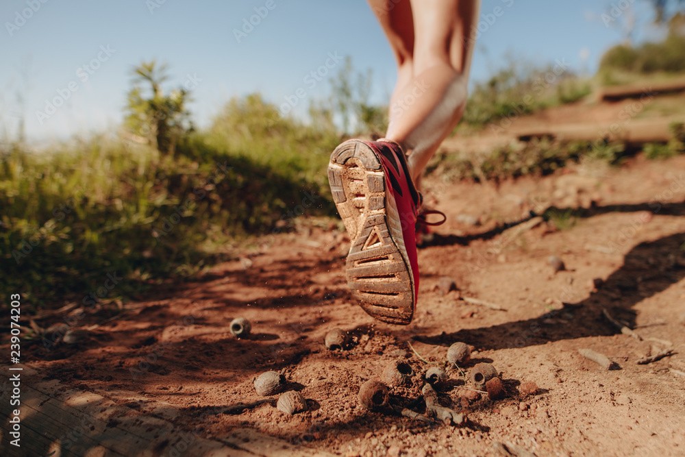 an athlete walking on a mud trail path