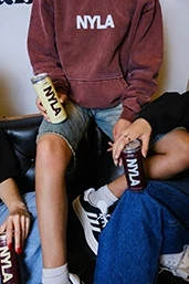 A group of friends on a couch enjoying NYLA.