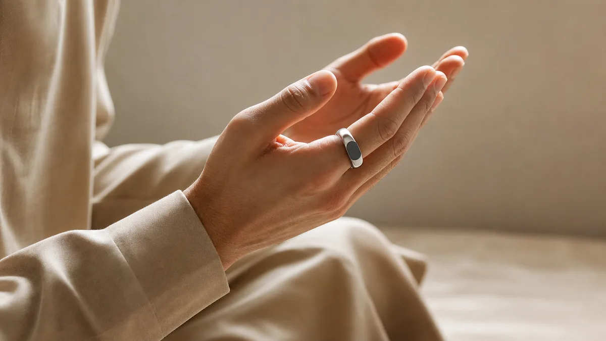 Hands raised in dua with a smart tasbih ring after prayer
