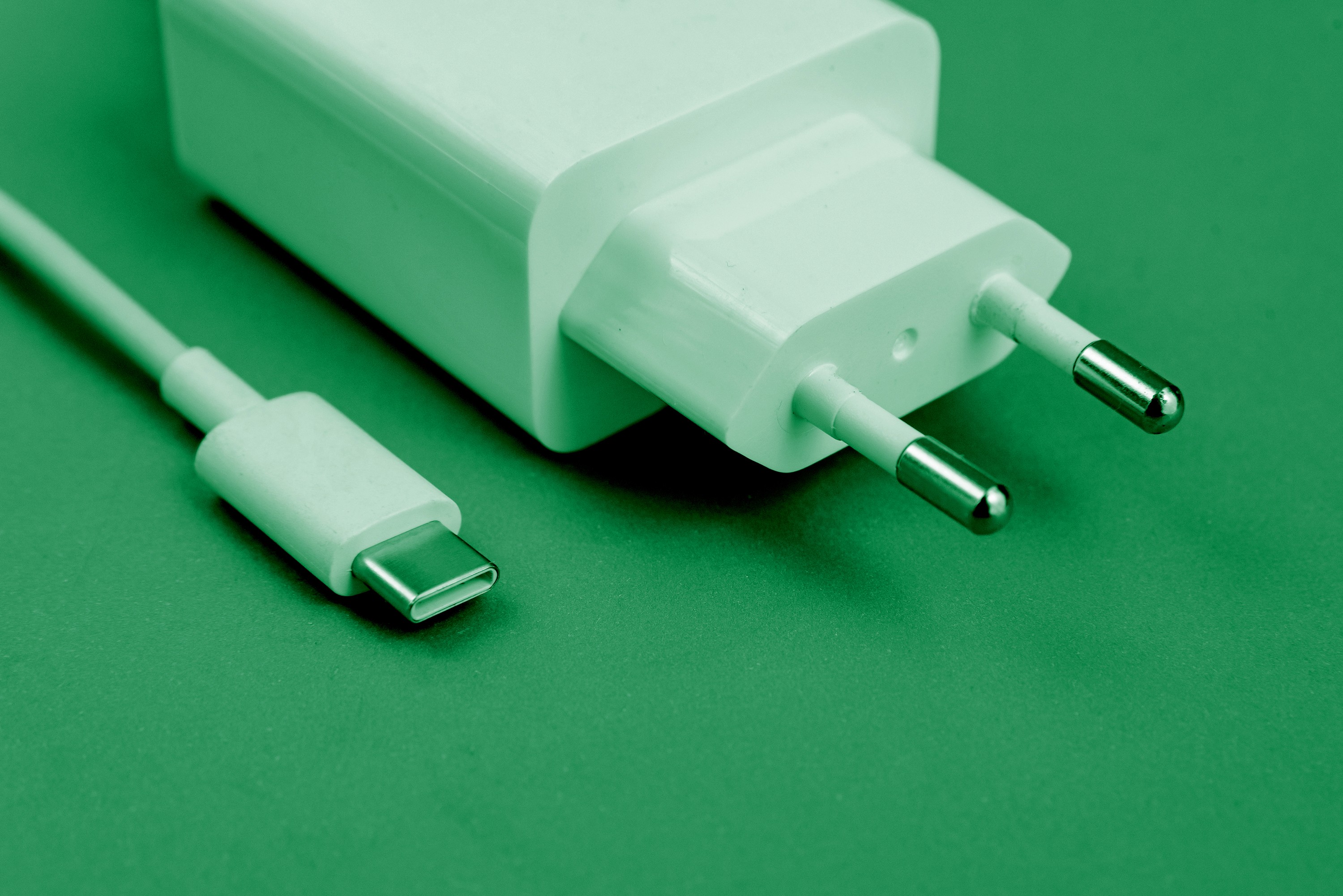 Historic buildings along a river under a cloudy sky.
