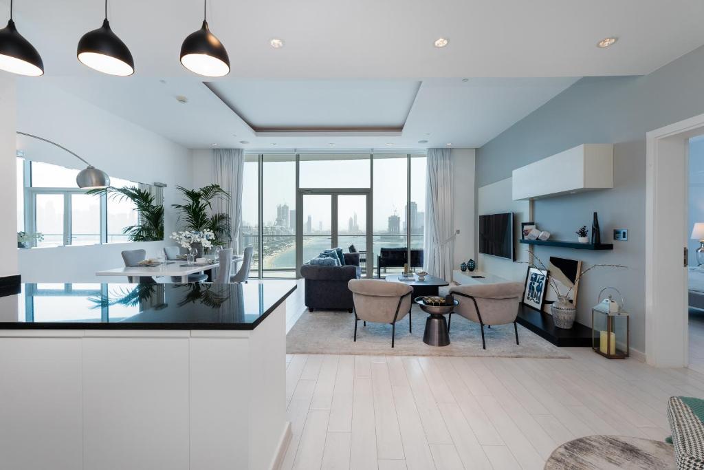 A well-furnished living room with a dining table and chairs, representing the chic design of Oceana Residences