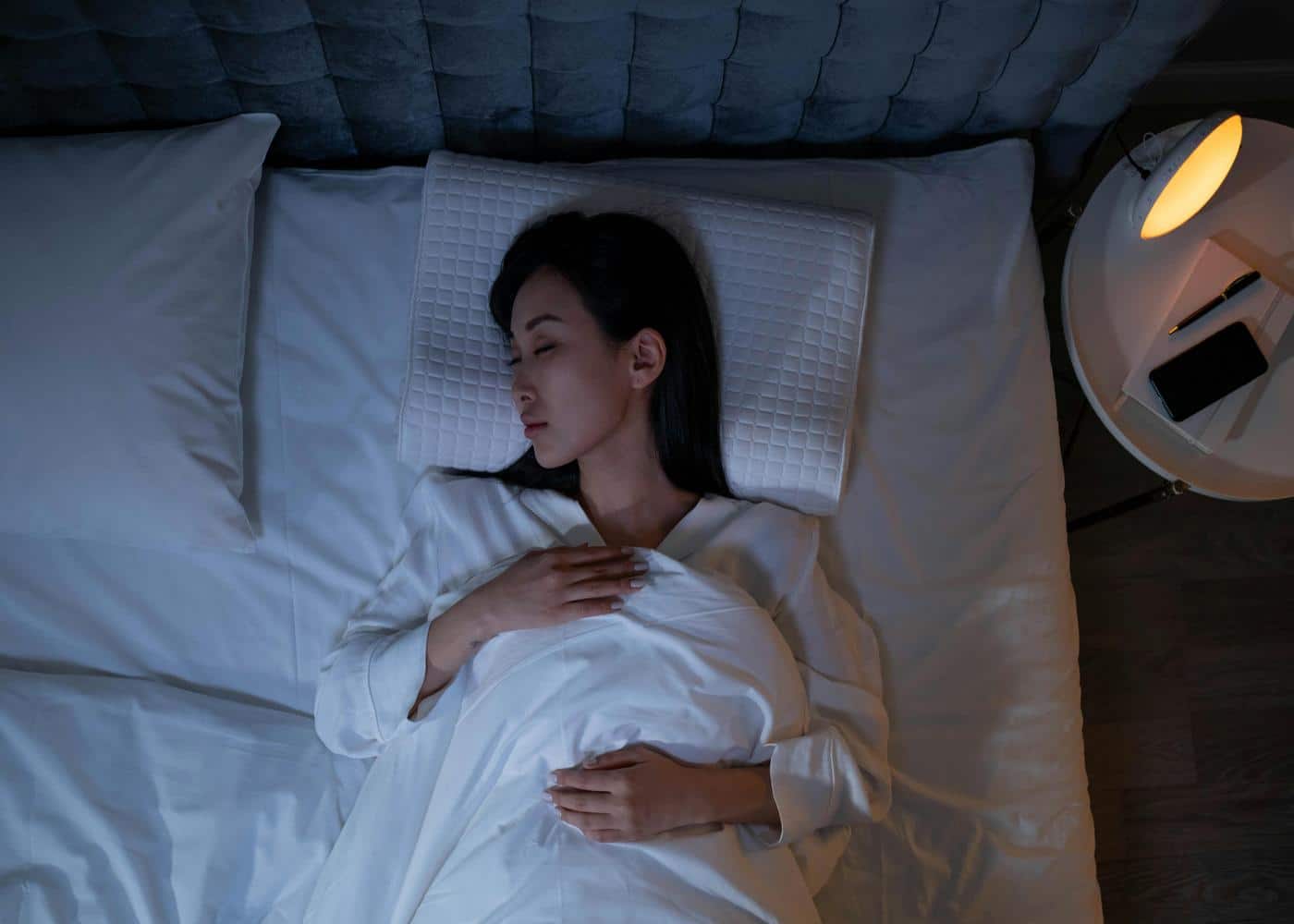 Woman sleeping peacefully in a bed