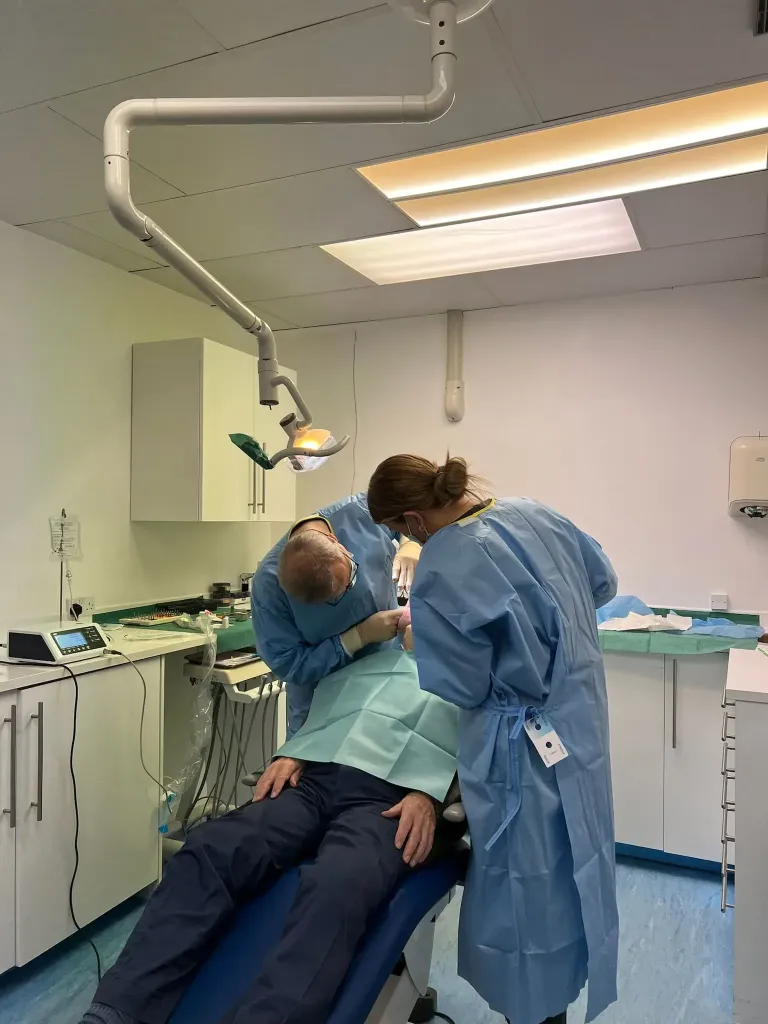 Dr Yasser and his nurse in surgery, to do some dental work on a patient.
