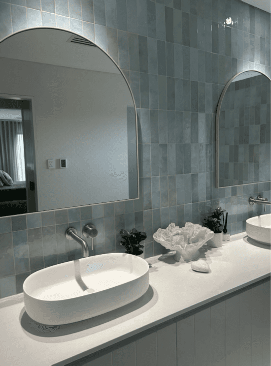 Twin vessel basins and arched mirrors gleaming after a residential bathroom clean in Perth