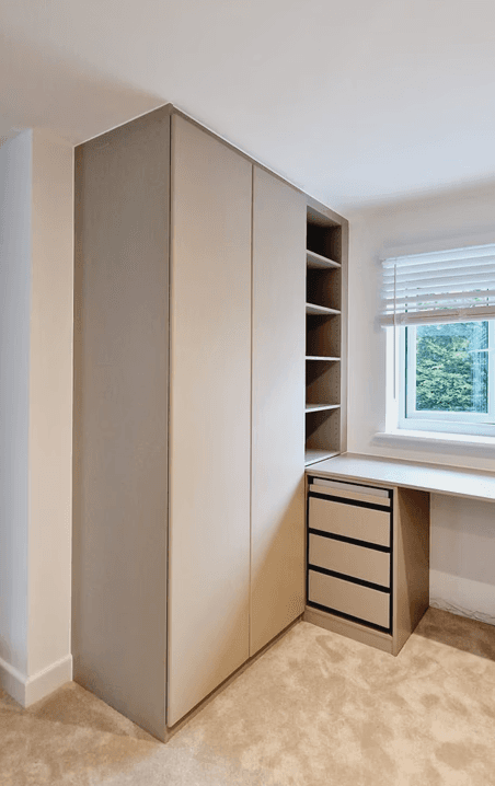wardrobe and a desk under a window