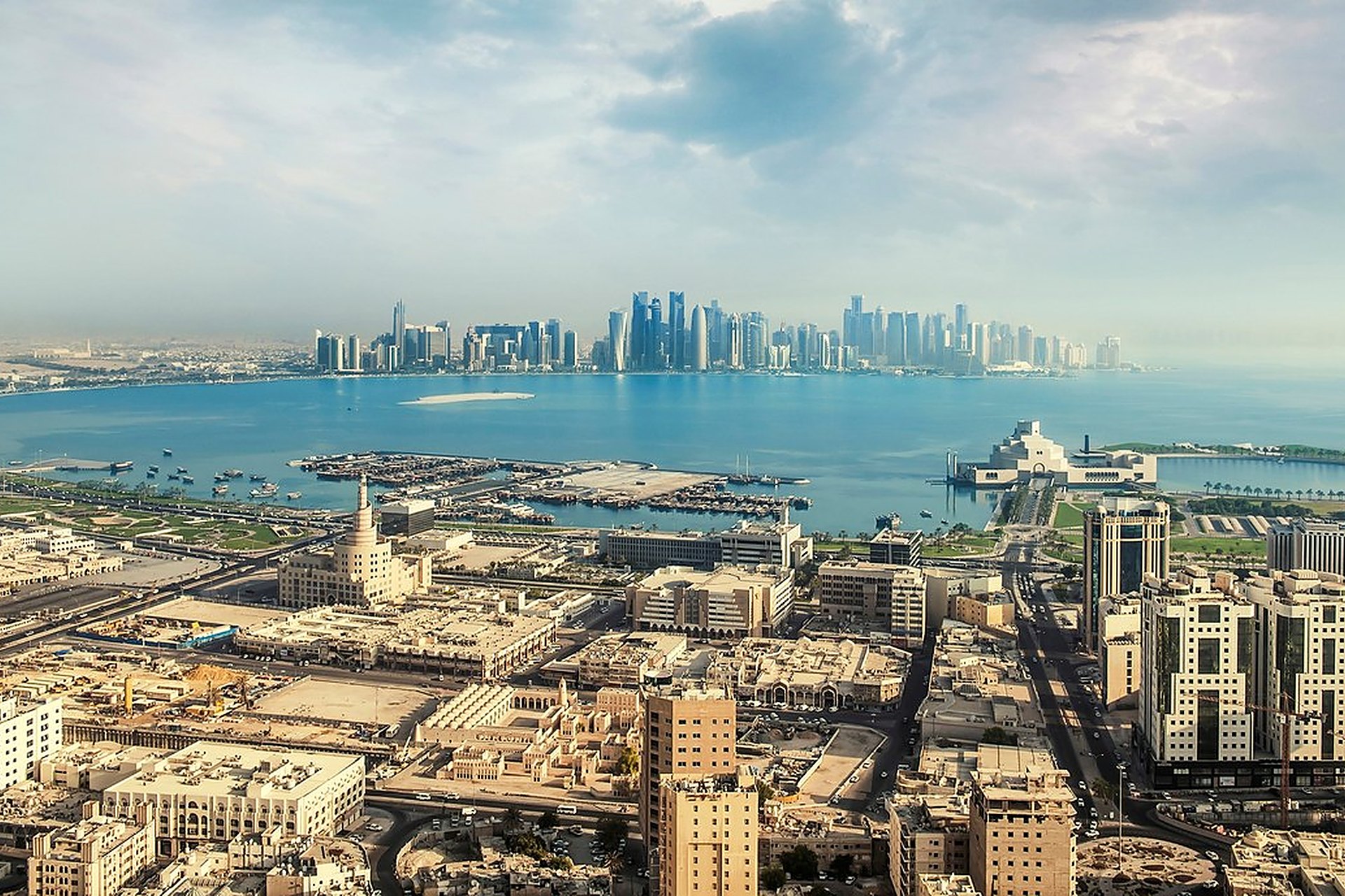 La baie de Doha vue d'en haut, avec le vieux Doha au premier plan et les tours de West Bay à l'horizon, un siècle après la perle