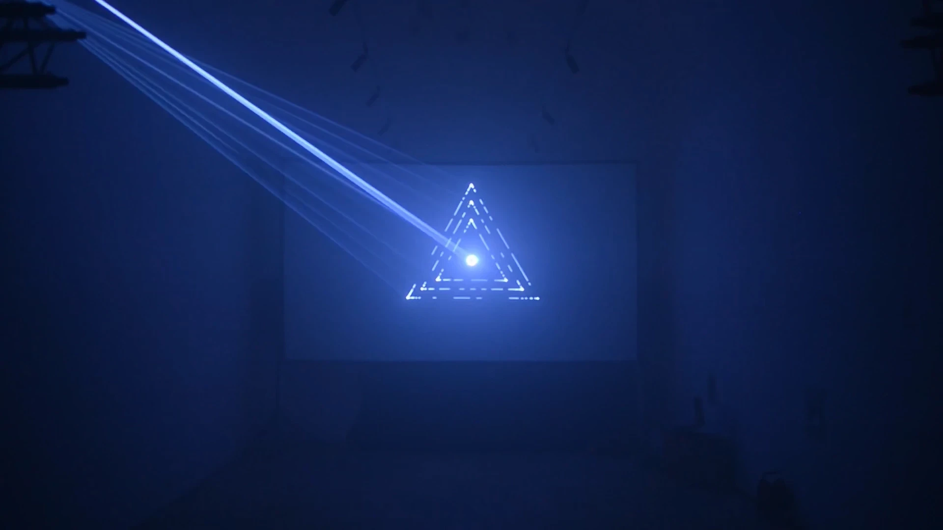 White triangle projection with blue laser beams.