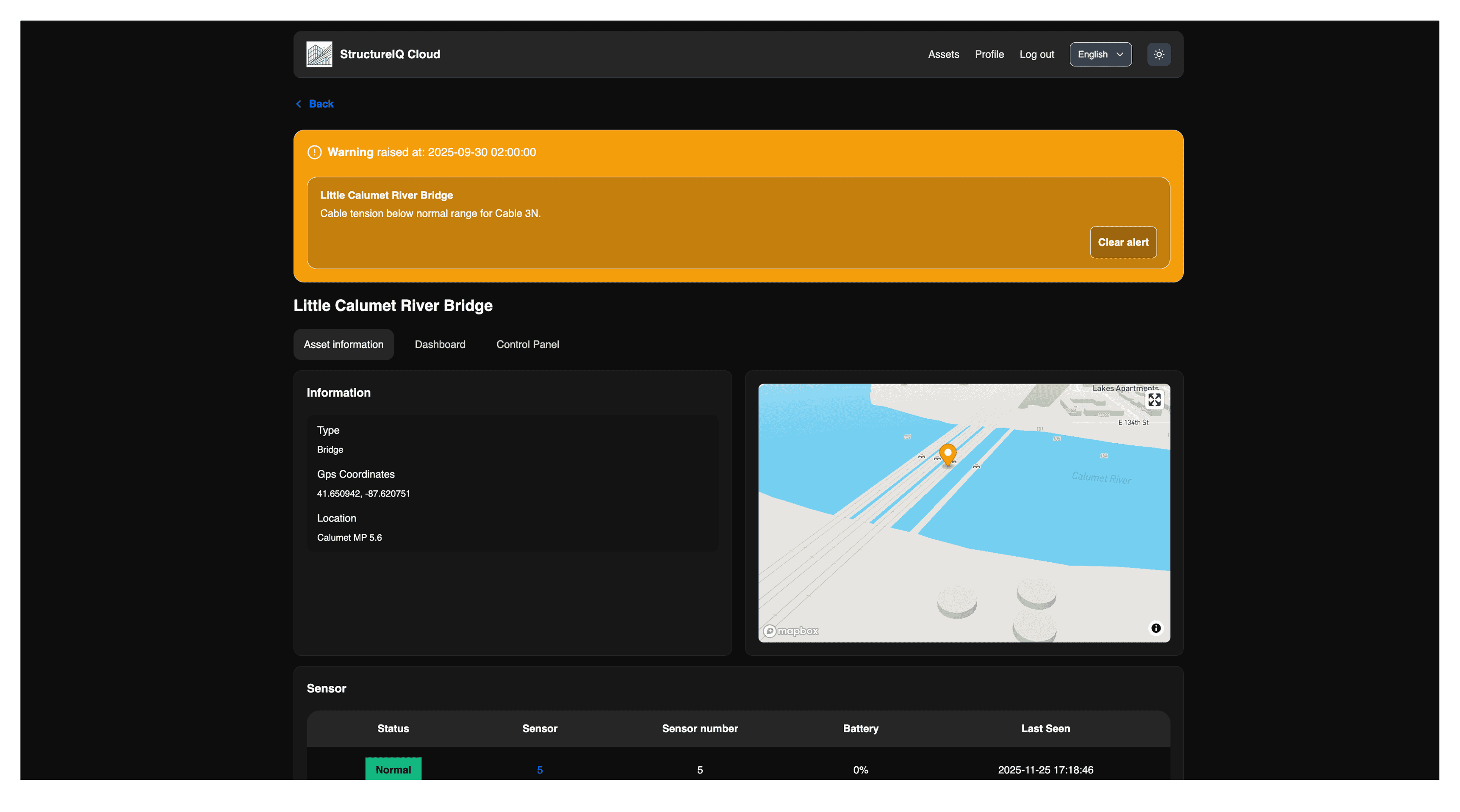 A large orange truck driving down a dirt road