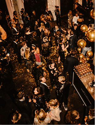 Crowded night festival with people and a gold-lit atmosphere