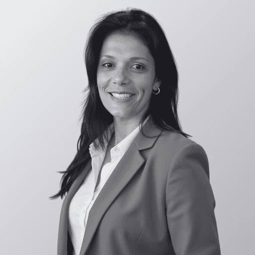 black and white photo of the upper part of white female in a suit with white shirt and smiling. This is the Head of Marketing, Carolina Wagner