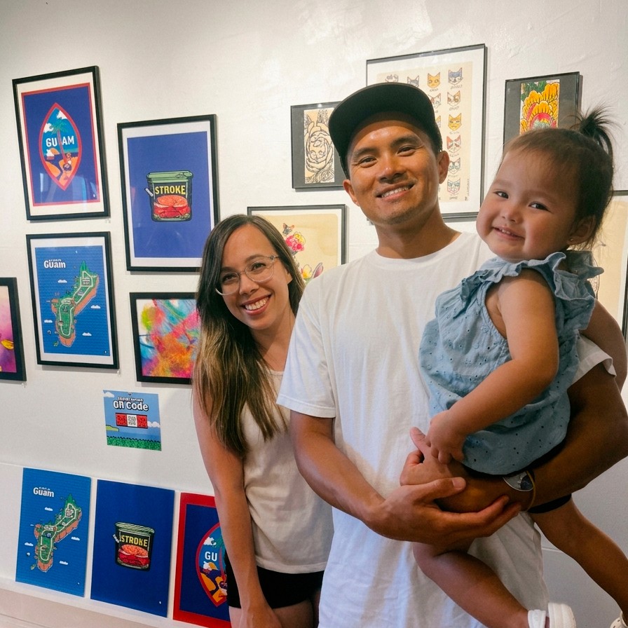 Two men discuss a project while standing at a laptop in an office.