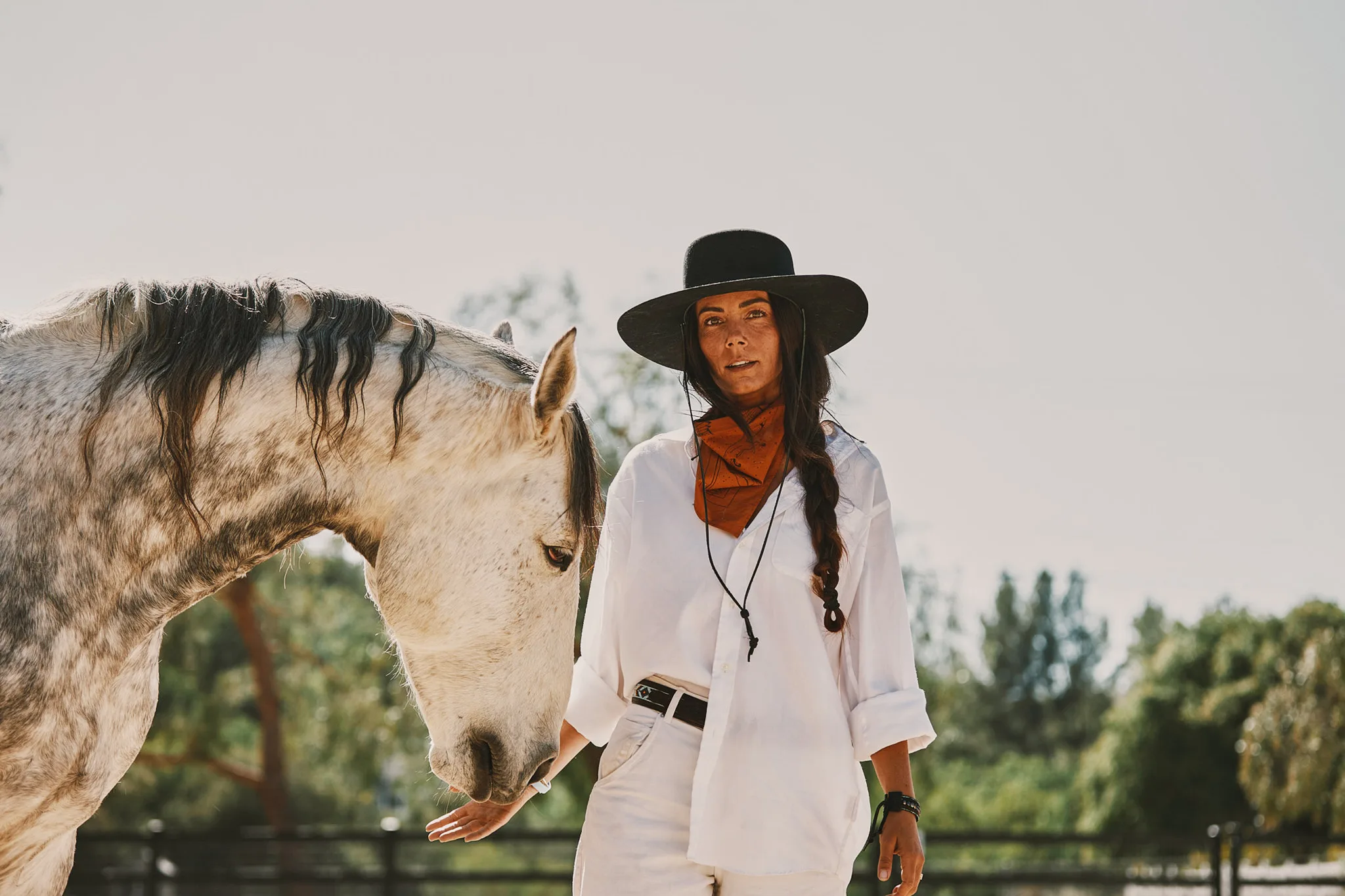 woman in black hat beside dappled horse — Alex Saidac photography by Tom Kubik