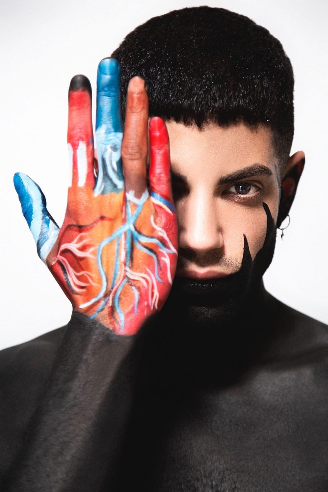 A lone astronaut sitting on a rocky surface, gazing at Earth from space.