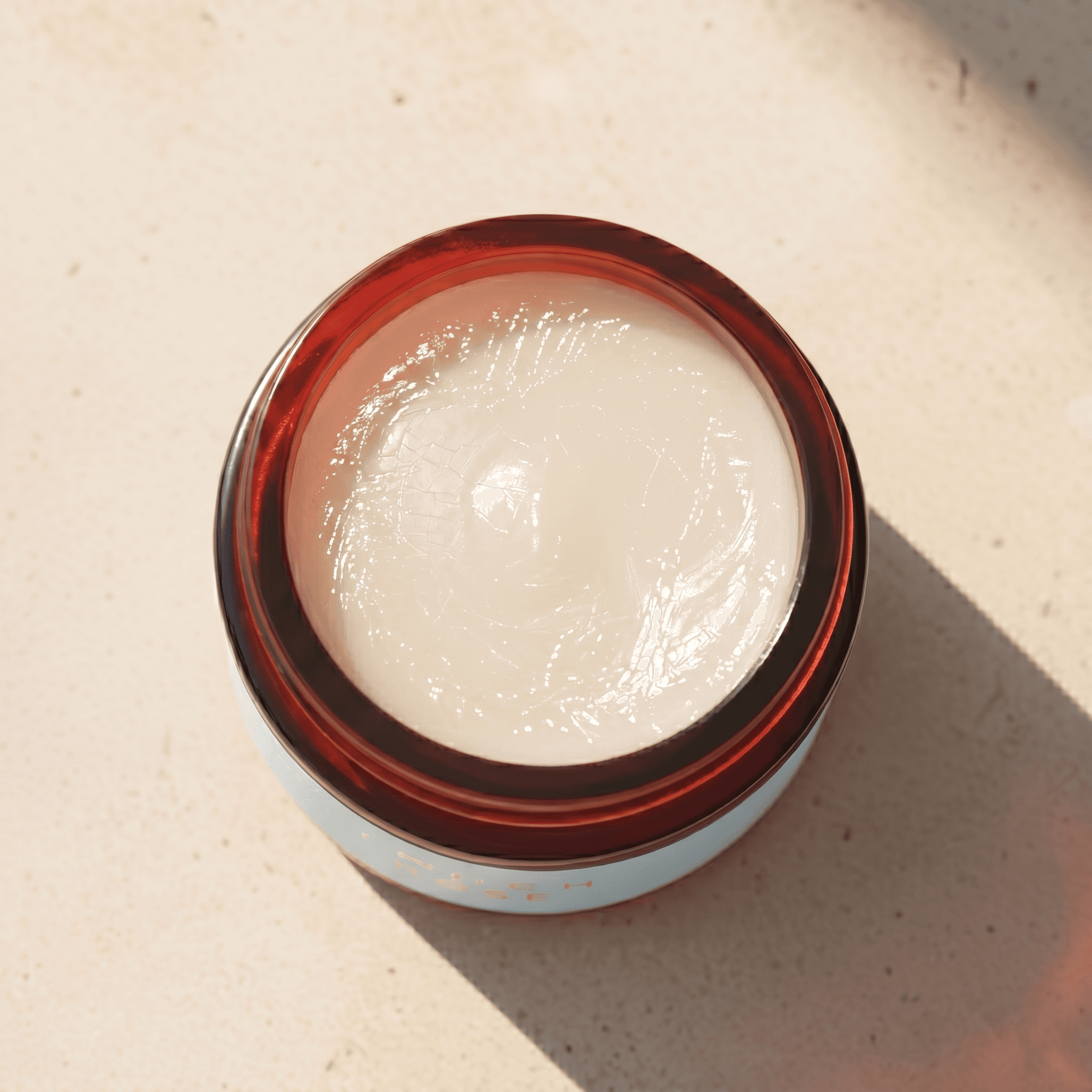 Open glass jar of dog balm showing smooth cream surface inside