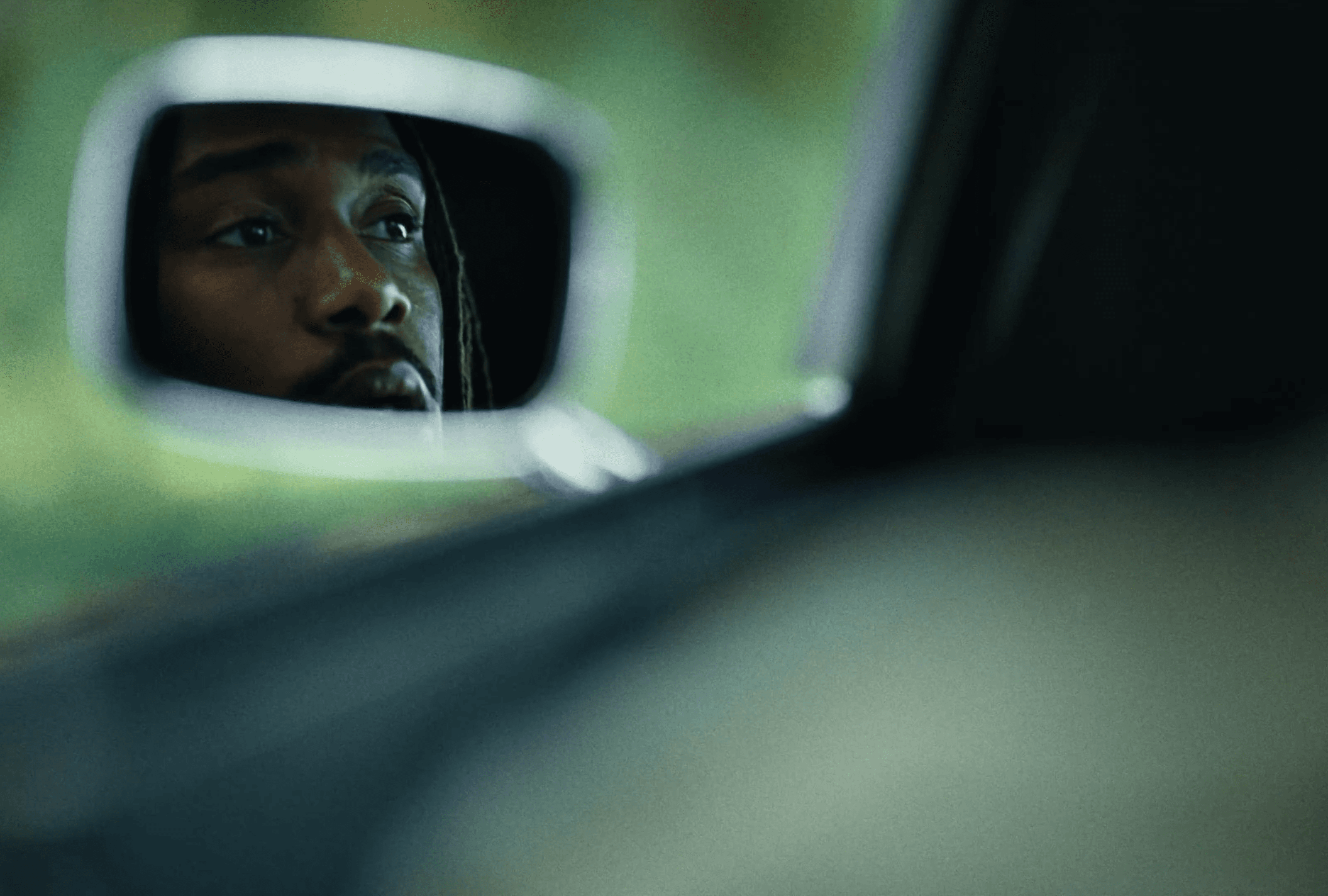 Family picking apples from a tree in an orchard.