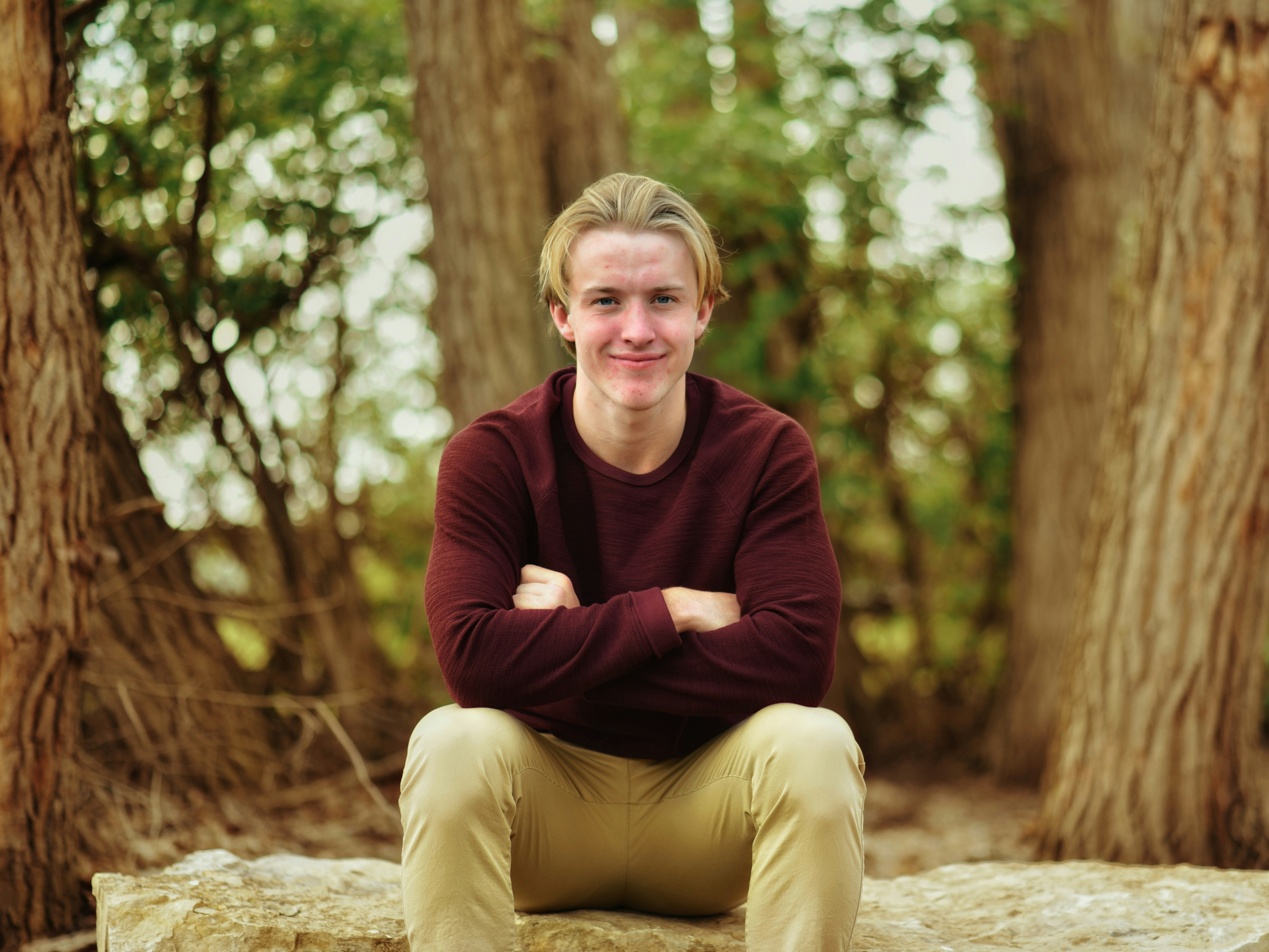 person sitting in woods - Fall Outfit Men