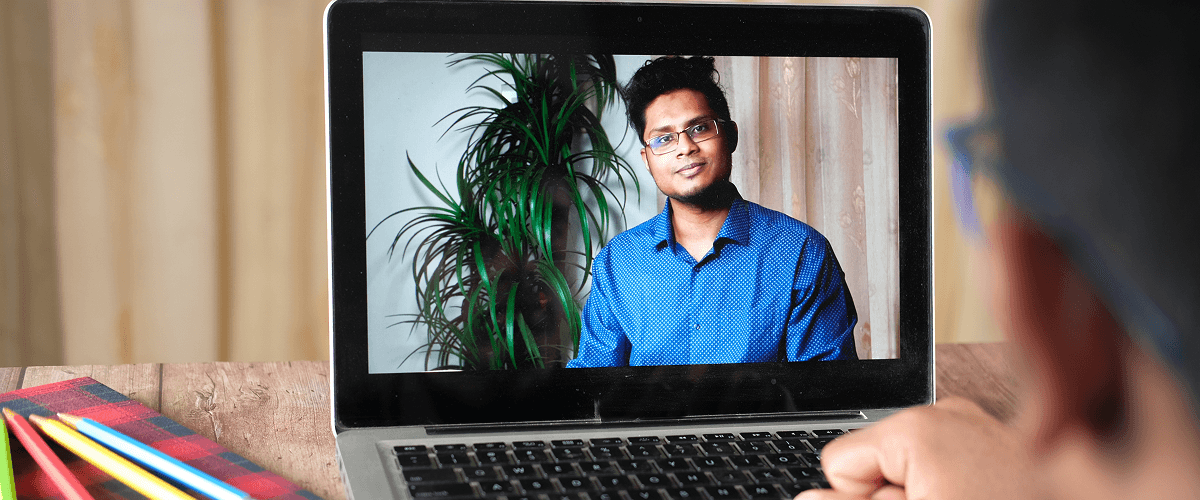 A job seeker viewing a company recruitment video on his laptop screen representing how company recruitment videos can enhance the hiring process.
