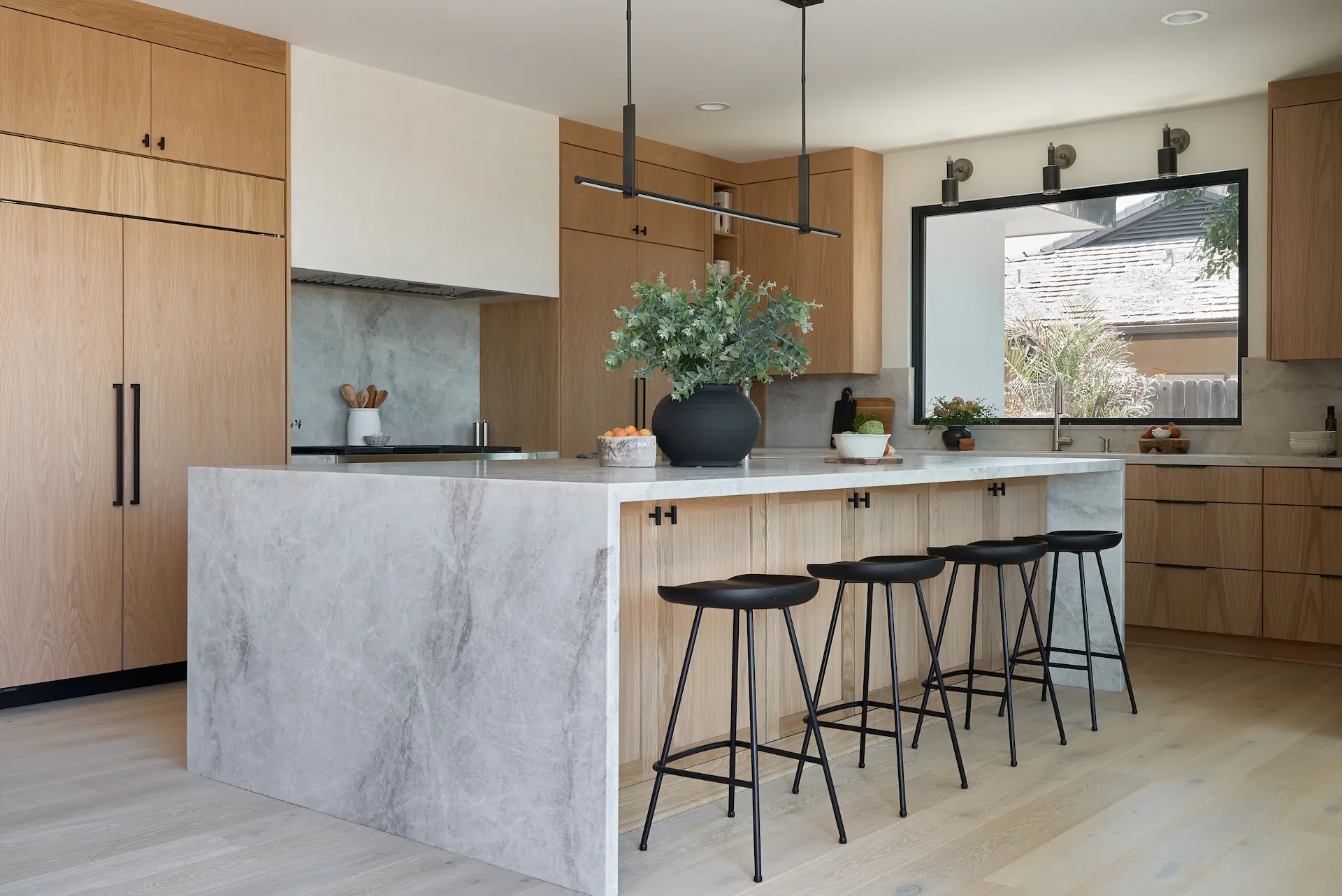 Wide-angle view of the modern kitchen in the Fullerton remodel project. Photo by Todd Huge.