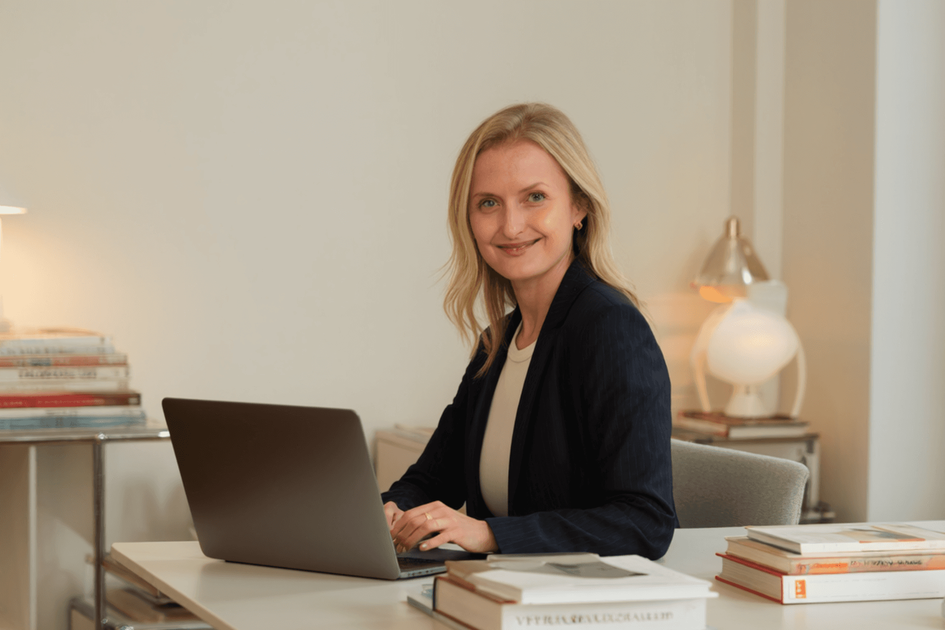 Smiling man with light brown hair and stubble, wearing a khaki shirt in natural light
