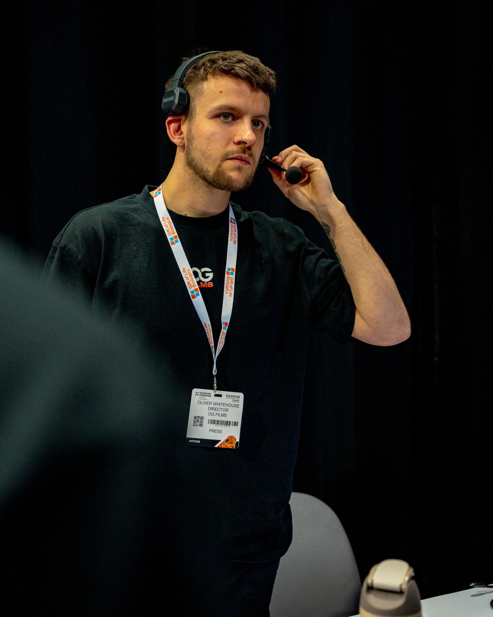 Black and white portrait of a smiling person with curly hair