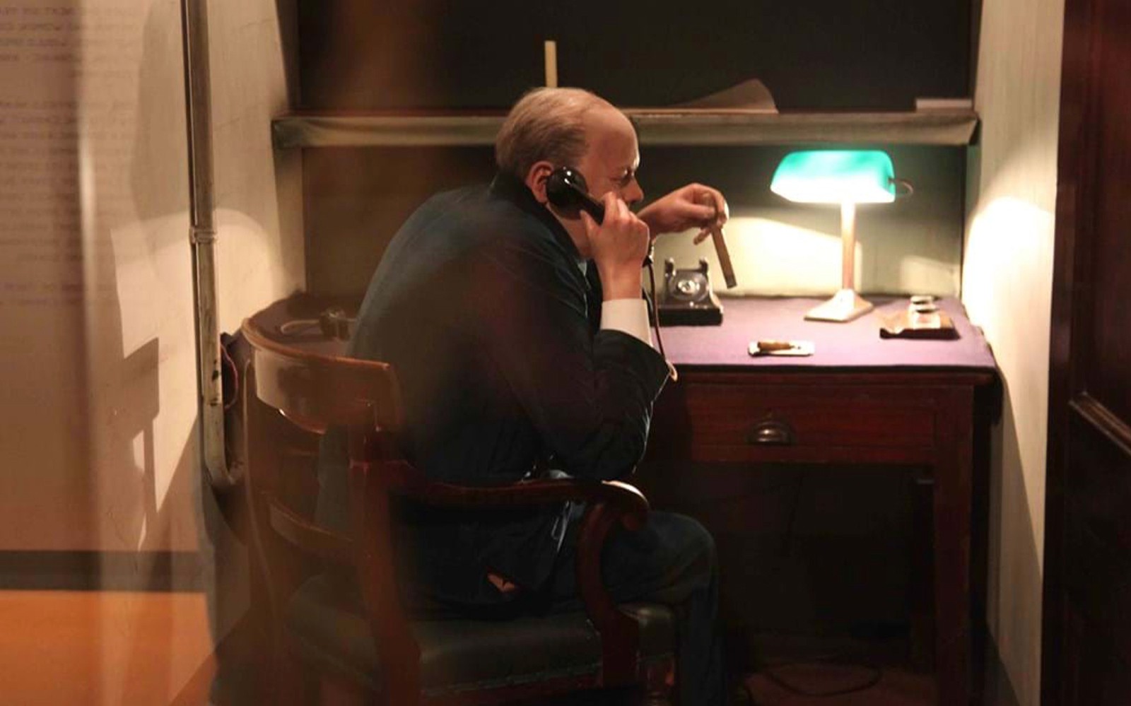 Man in WWII-era office using a phone, part of Churchill’s War Rooms tour.